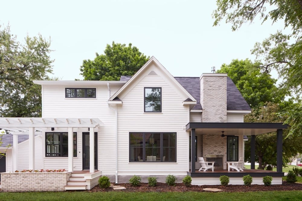 Black Windows Add Modern Flair To Updated Farmhouse modern farmhouse with black windows and doors