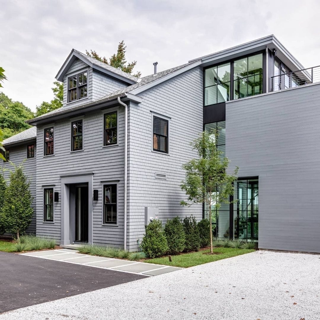 The exterior of a gray house with black windows lends contemporary style.
