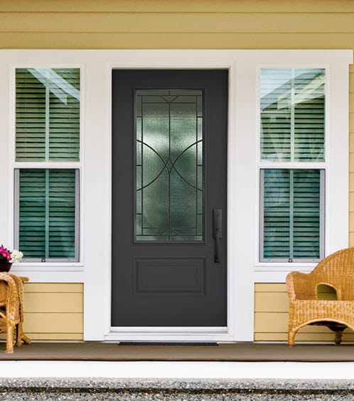 exterior of a yellow home with a new fiberglass front entry door with decorative glass