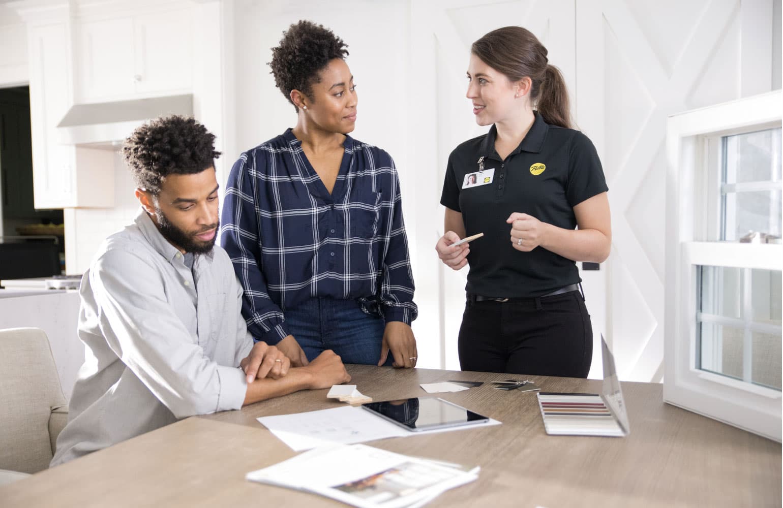 three people looking at swatches as they decide on a window purchase