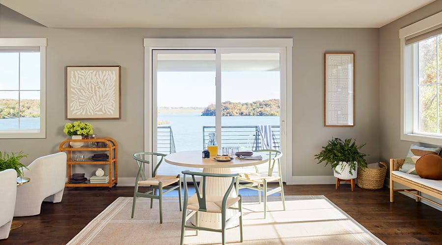 Beige-colored home interior featuring a large sliding patio door that opens to the lake outside.
