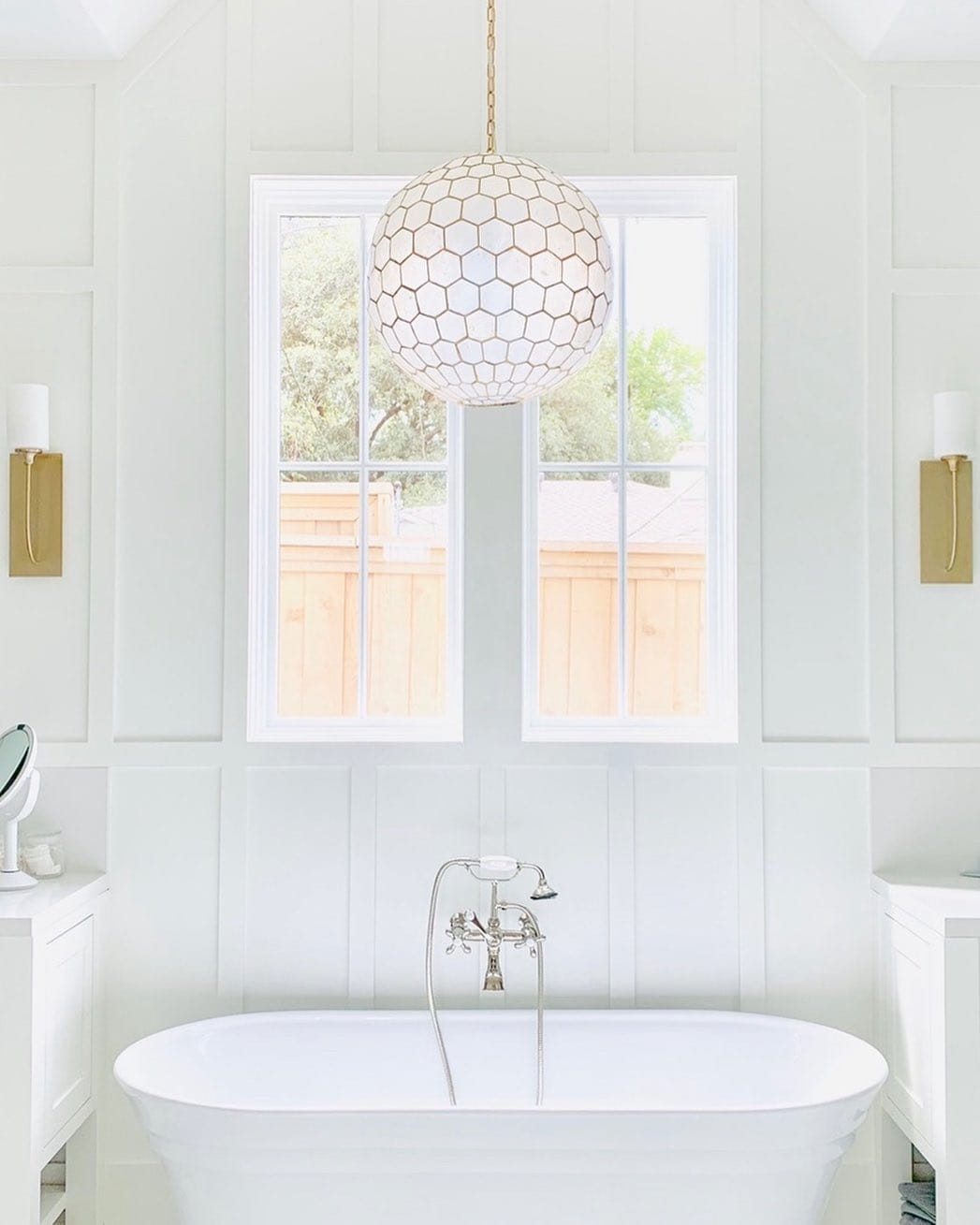 White Picture Windows Complete Dreamy Bathroom Design Freestanding bathtub with white picture windows above and a glass pendant light