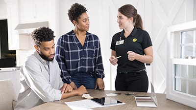 a man and woman talking sales with a pella saleswoman