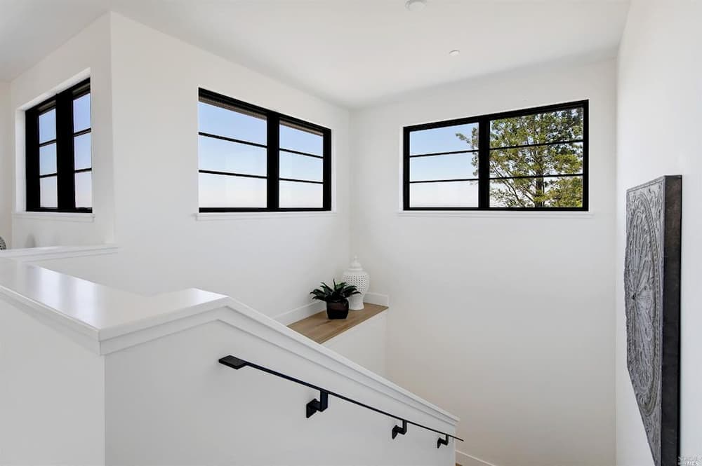 Black Window Grilles Emphasize Clean Lines In Modern Home Modern black windows situated high up in white stairway