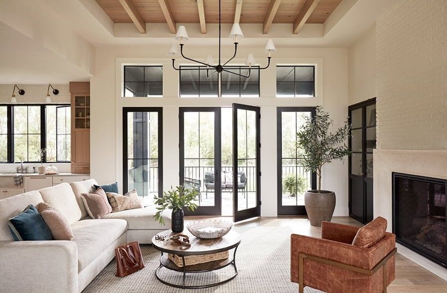 Contemporary living room with double black patio doors and a fireplace