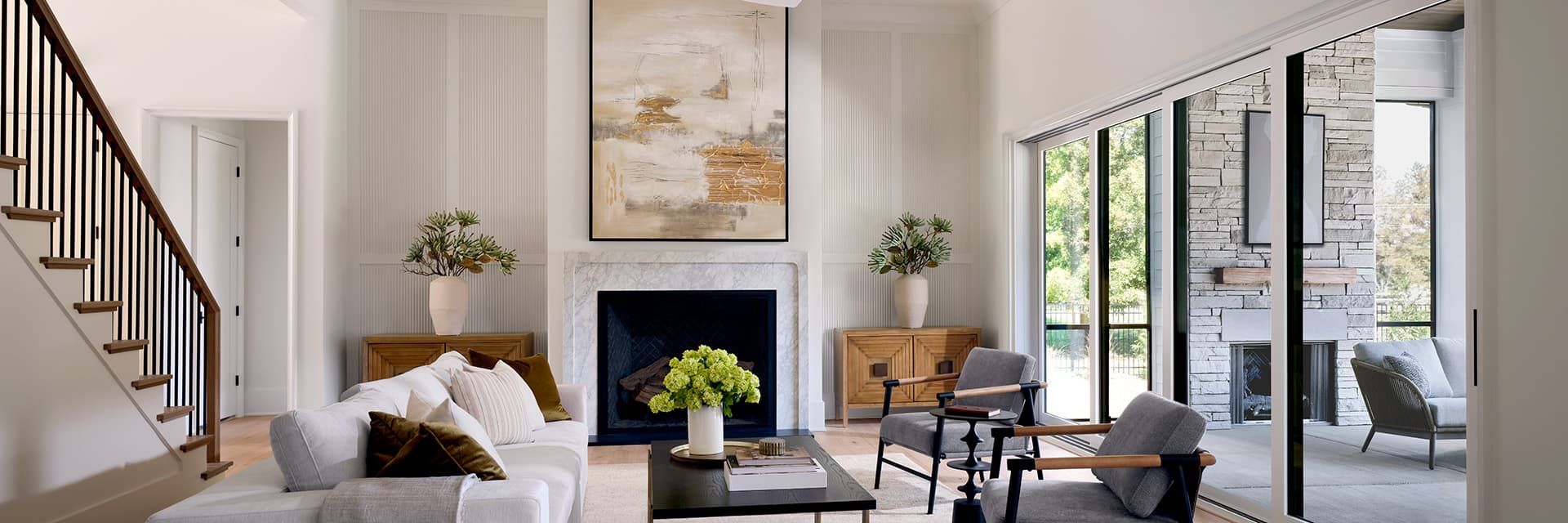 Modern living room with Pella Windows and doors featuring large sliding glass doors and elegant decor.