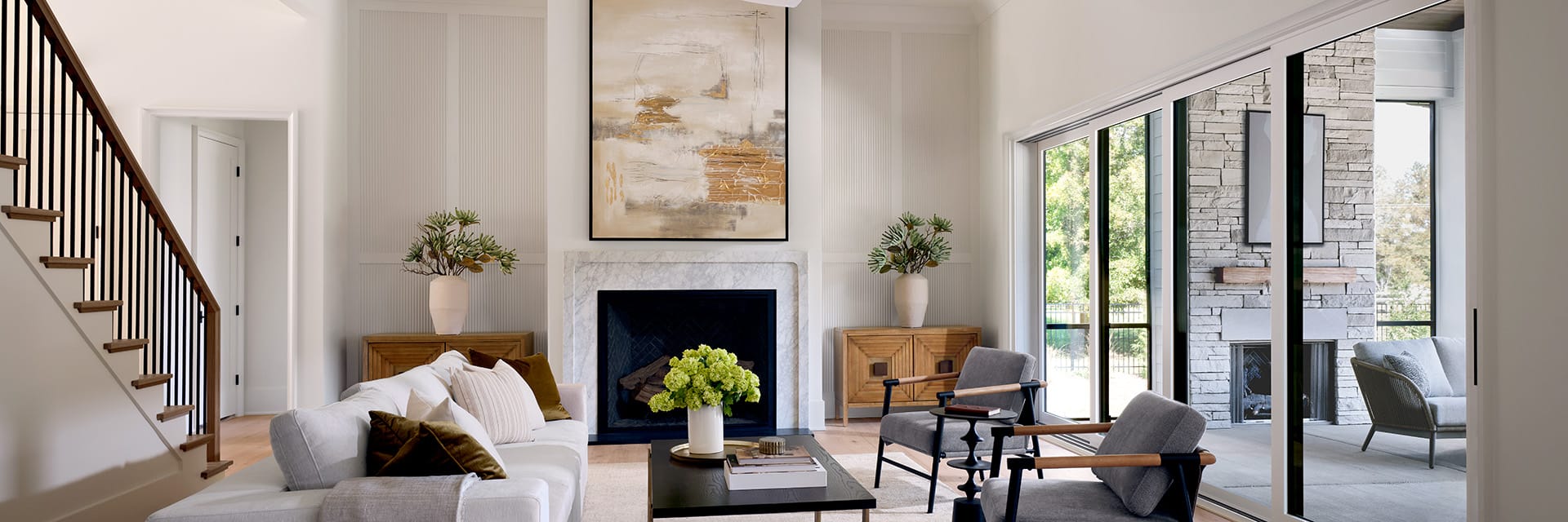 Modern living room with Pella Windows and doors featuring large sliding glass doors and elegant decor.