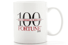 The Fortune 100 logo, dated from 2000, on a coffee mug.