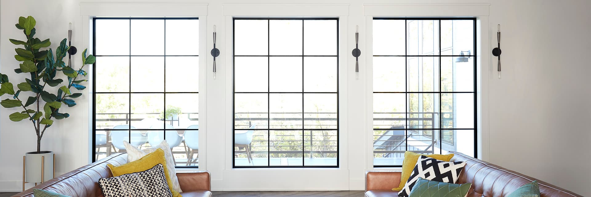 Black windows with a traditional grille pattern overlooking backyard patio.