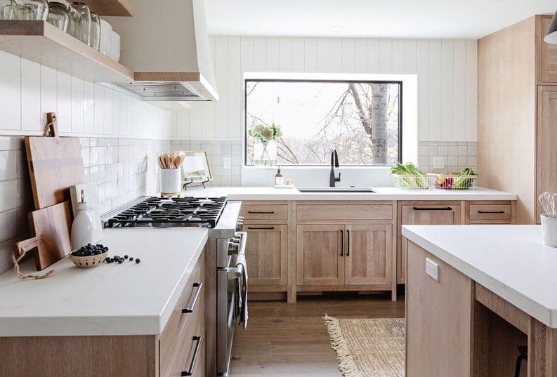 A large picture window over kitchen sink lets natural light flood the room.