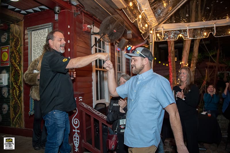 two contractors give each other a high five as the celebrate their successes in 2021