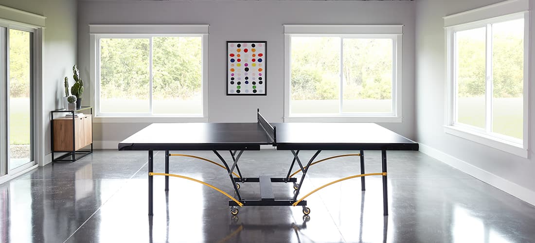 polished cement recreation room with 250 series vinyl windows and patio doors on all walls