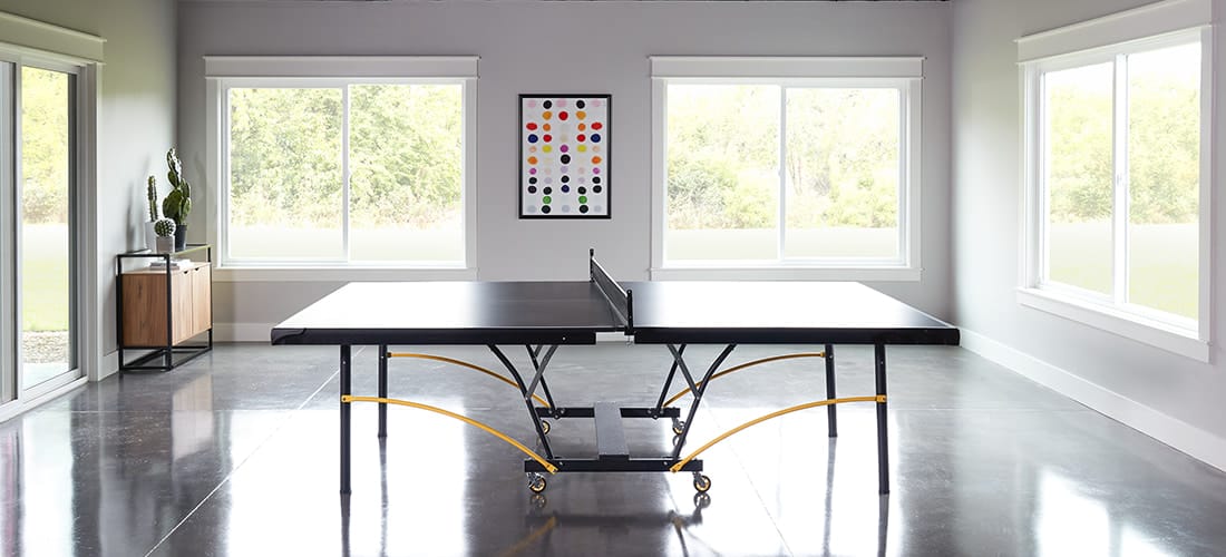 polished cement recreation room with 250 series vinyl windows and patio doors on all walls