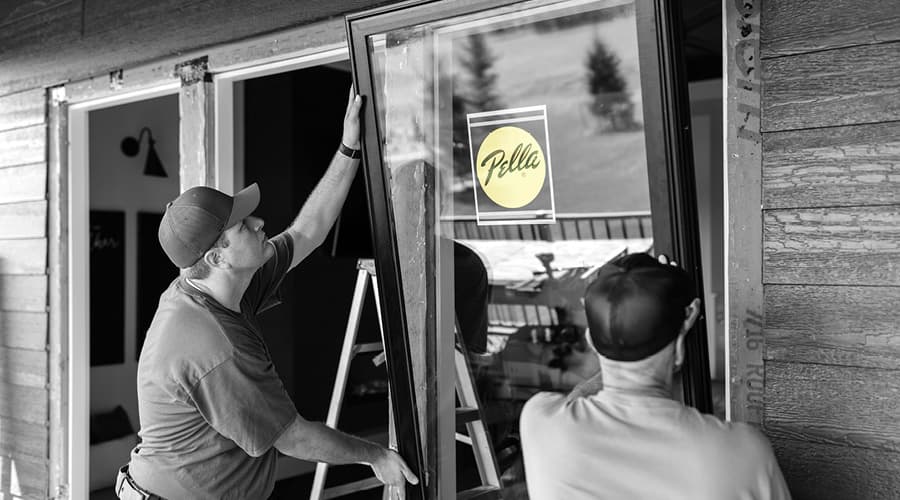 two contractors installing a new window