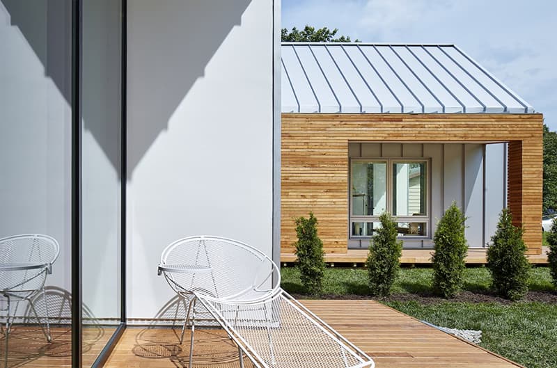 Modern Home Mixes Materials, Colors, & Window Combinations contemporary Patio on modern home has a chair alongside large white picture window