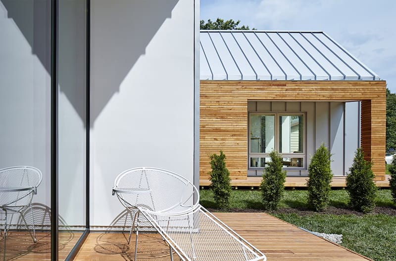 Modern Home Mixes Materials, Colors, & Window Combinations contemporary Patio on modern home has a chair alongside large white picture window