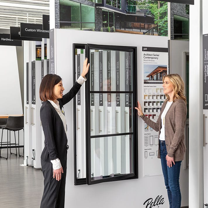 Expert showcasing a display in Pella showroom floor.
