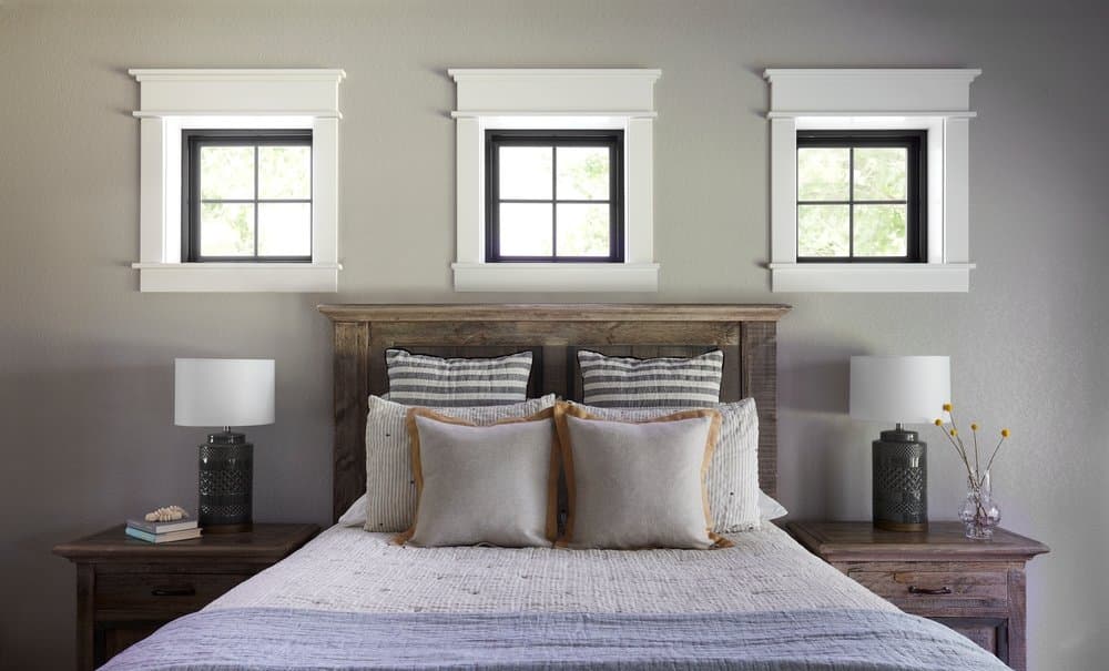 Black Windows With White Trim Creates A Classic Look Three square black windows with white trim above bed