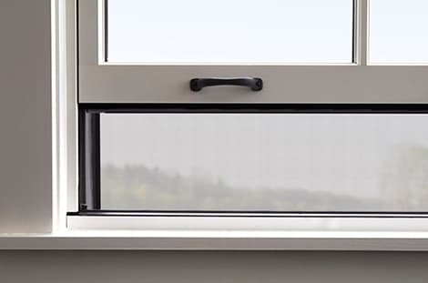 rolscreen integrated screen on a double-hung window
