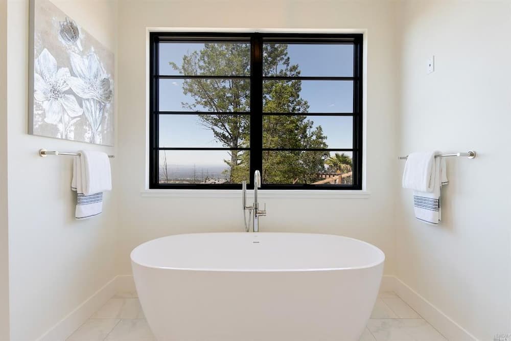 Black Windows With Modern Grilles Create Beautiful Contrast Black windows with horizontal grilles contrast against white bathroom