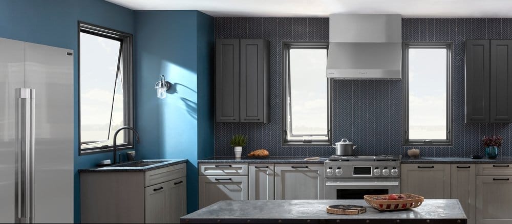 Awning Windows Act As Works Of Art In Dark & Moody Kitchen Tall awning windows light dark blue and gray kitchen