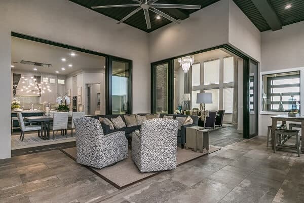 Multi-Slide Patio Doors Seamlessly Connect Entertaining Areas Patio space connected to indoor dining area by three multi-slide patio doors