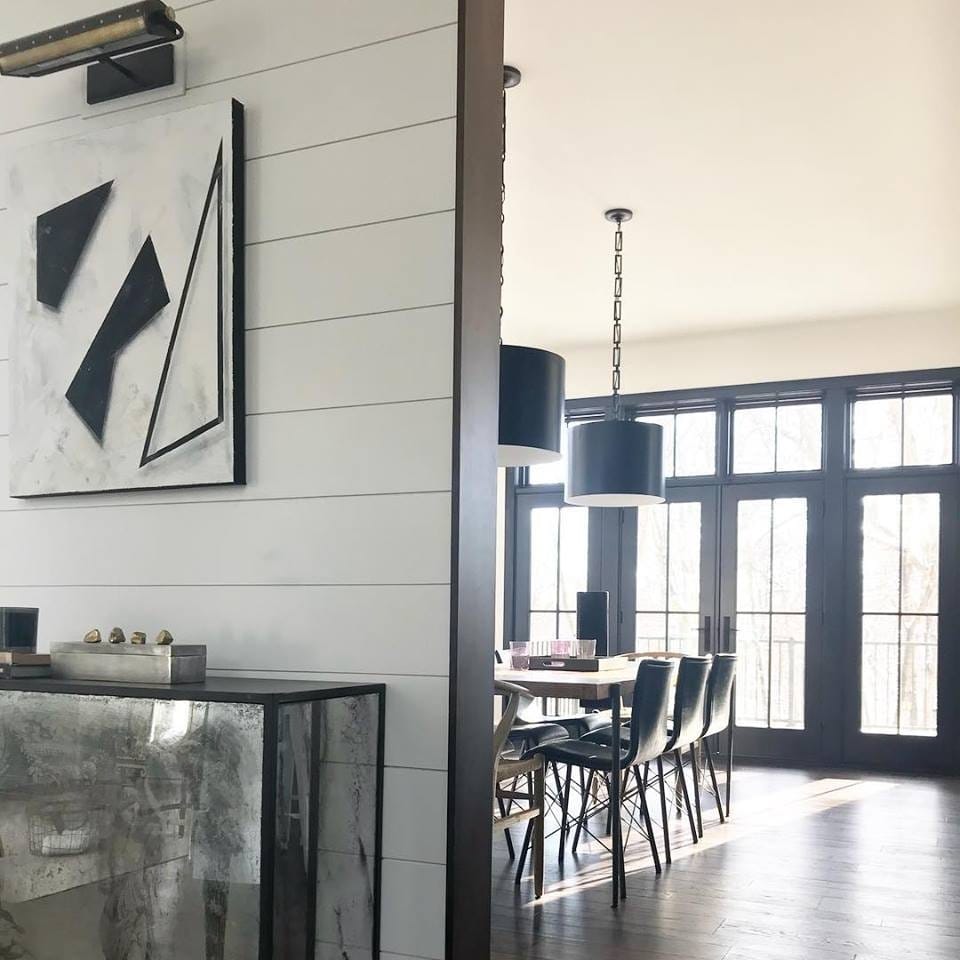Classic French Doors Bring Unexpected Twist To Dining Room black and white contemporary dining room with a wall of black french doors