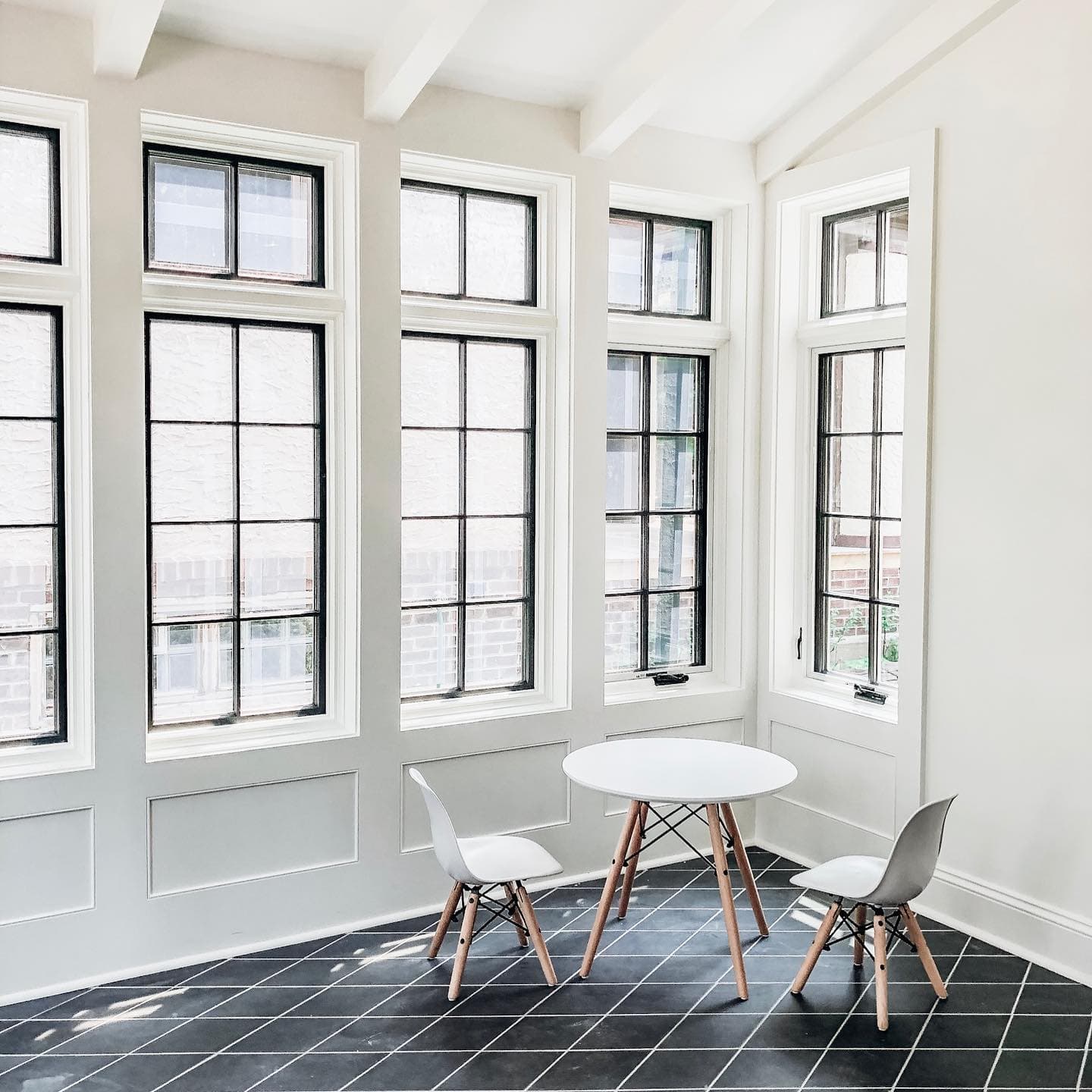 Black Frame Windows Showcase Classic Grille Pattern Wall of black frame windows with white trim for kid's playroom