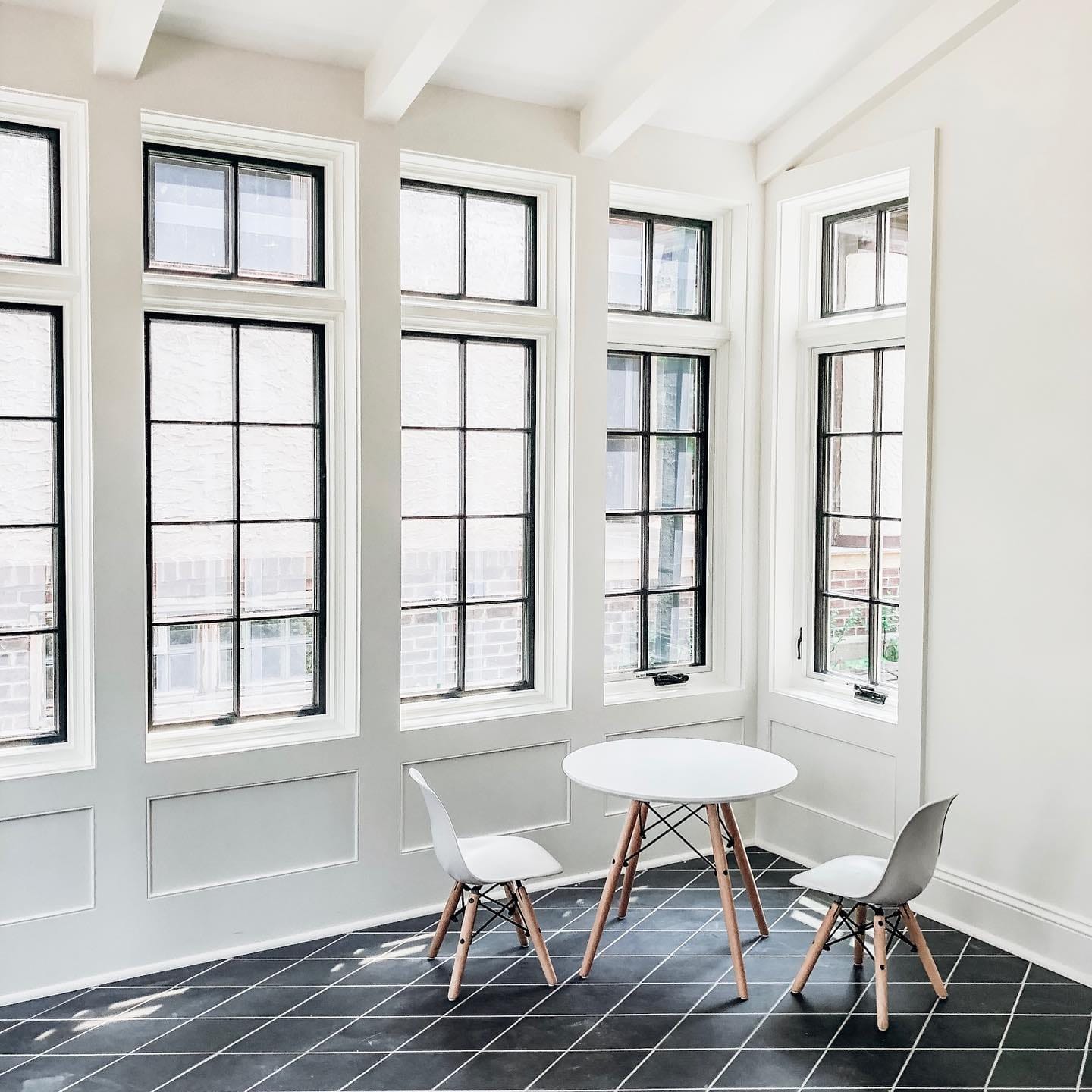 Black Frame Windows Showcase Classic Grille Pattern Wall of black frame windows with white trim for kid's playroom