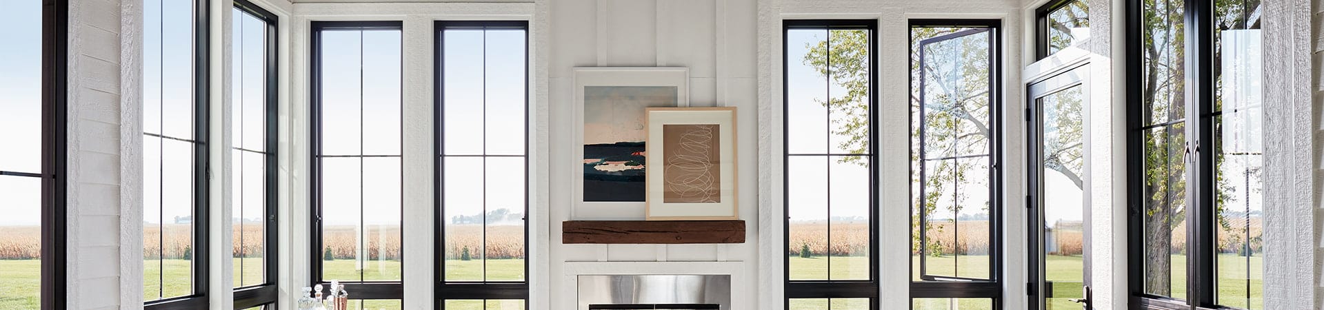 six black casement windows with custom grille patterns frame a contemporary living room