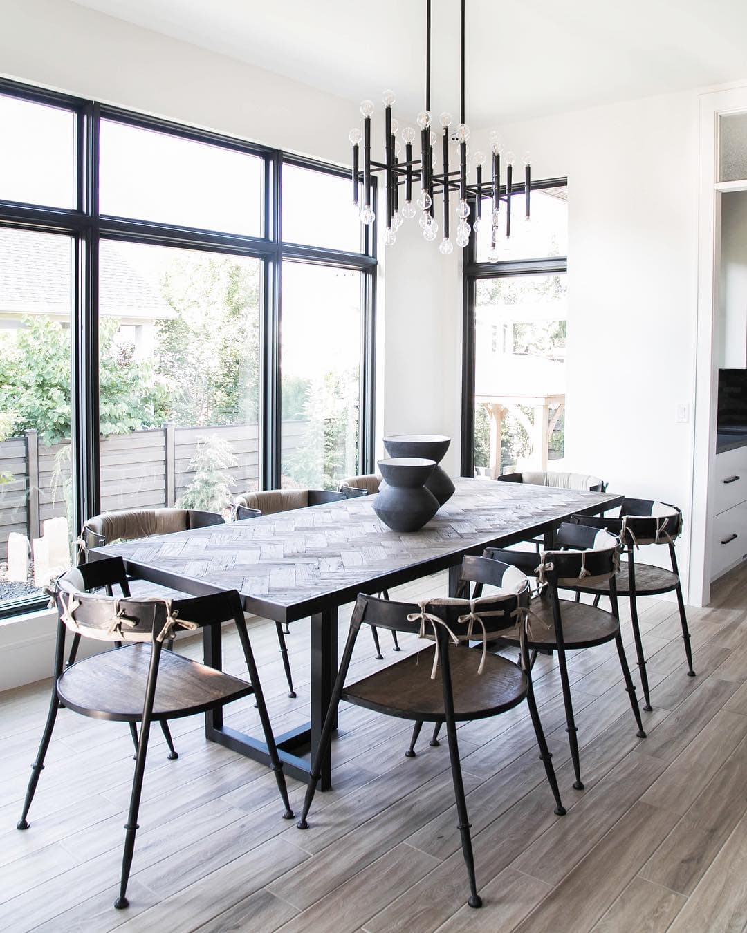 Modern Dining Room Features A Wall Of Black Frame Windows Wall of black picture windows in modern dining room