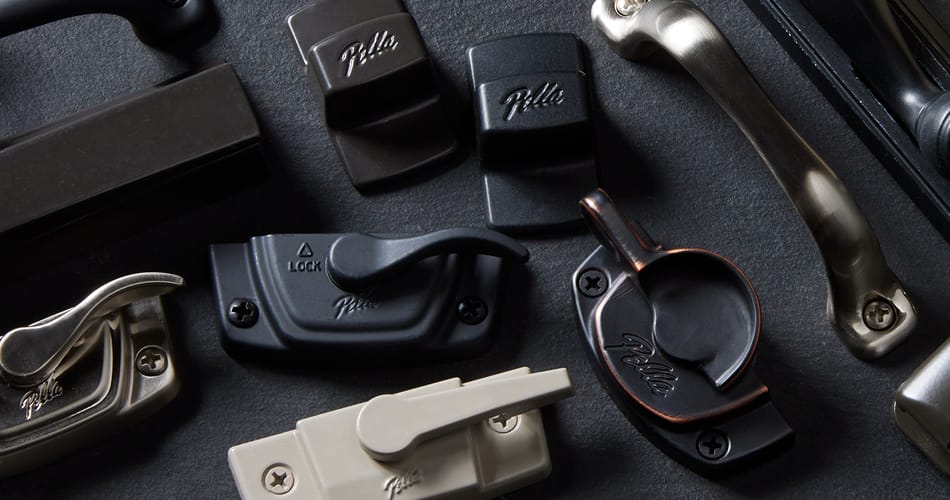 several pieces of Pella hardware in various colors.