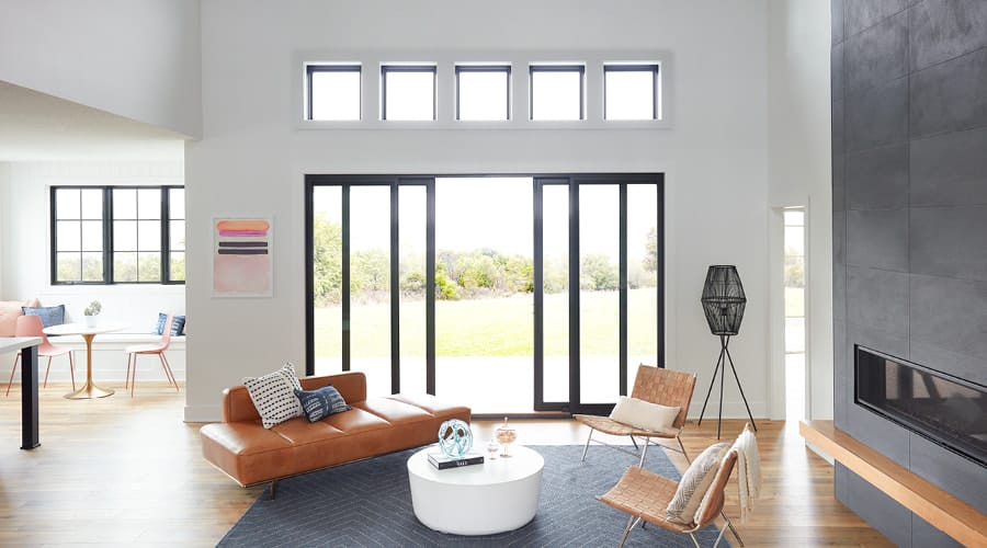 Sliding black French doors in clean, modern living room