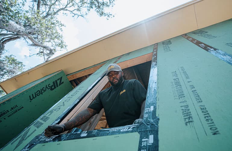 A Pella installer is ensuring the installation of a window is correct to encourage proper thermal performance.