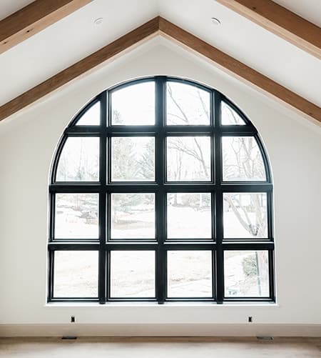Custom Shape Arched Window Showcase Design Possibilities Large custom arched black window in remodeled home