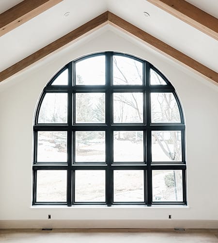 Custom Shape Arched Window Showcase Design Possibilities Large custom arched black window in remodeled home