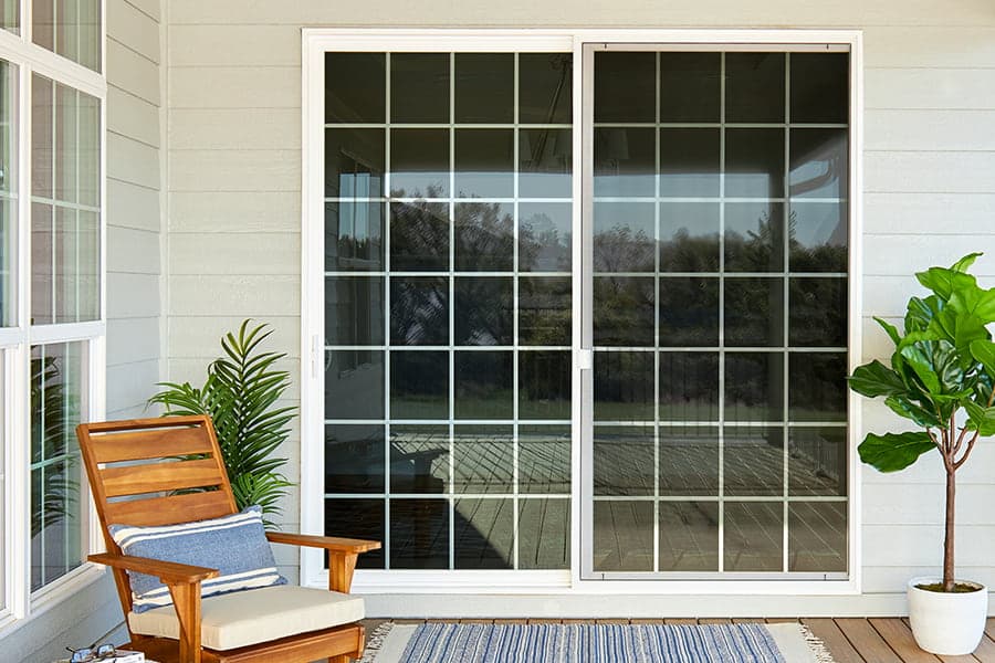 sliding patio door newly installed as viewed from a wooden deck