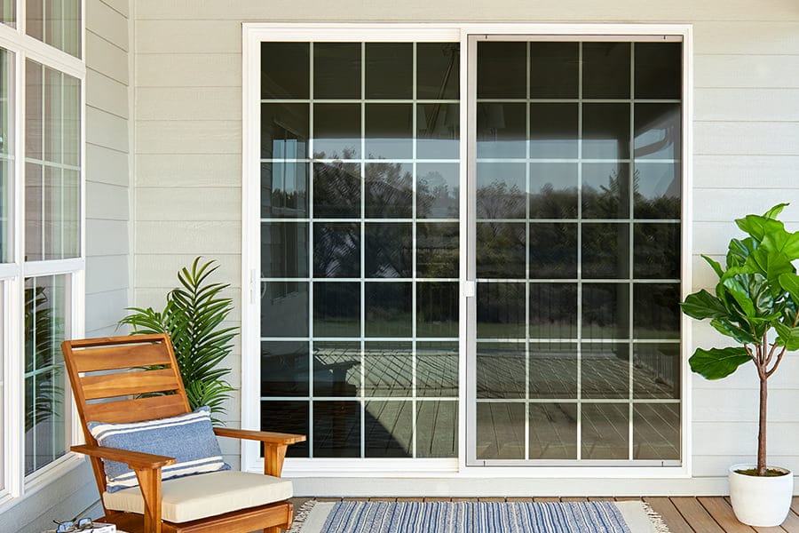 sliding patio door newly installed as viewed from a wooden deck