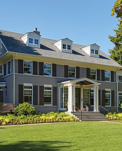 Exterior shot of traditional colonial replacement project home.