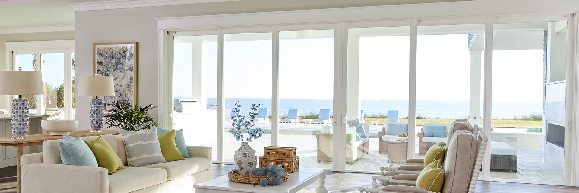Hurricane Shield french sliding doors open to an ocean view