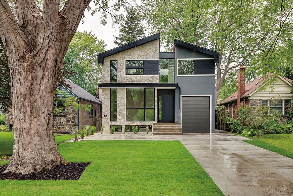 A custom home with brick on the left half of the house and modern siding on the right side.