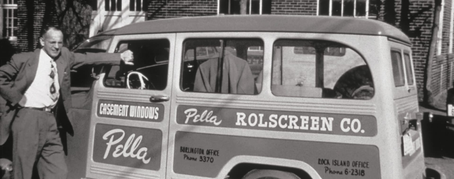 Pete Kuyper standing next to an original Pella delivery truck.